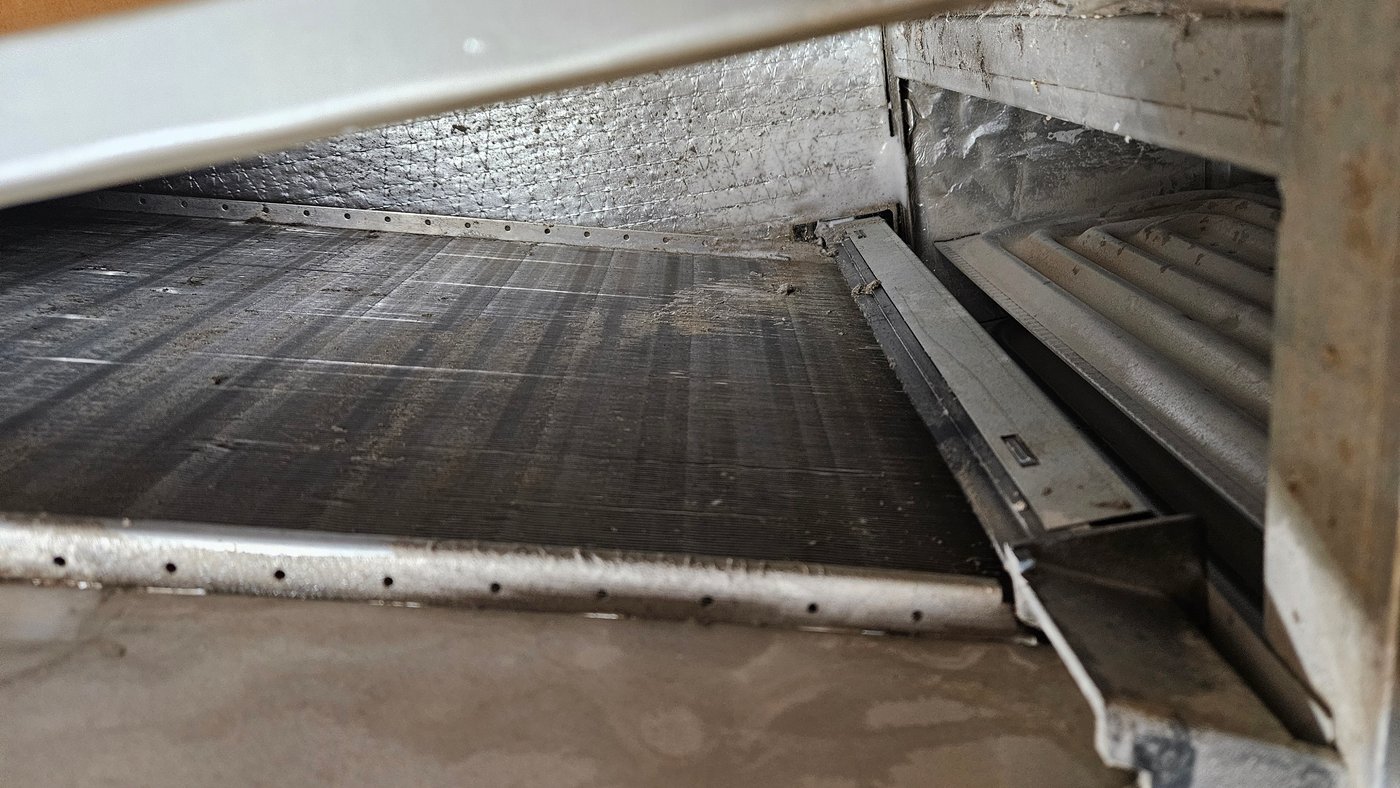 Severely clogged evaporator coil and drain pan restricting airflow