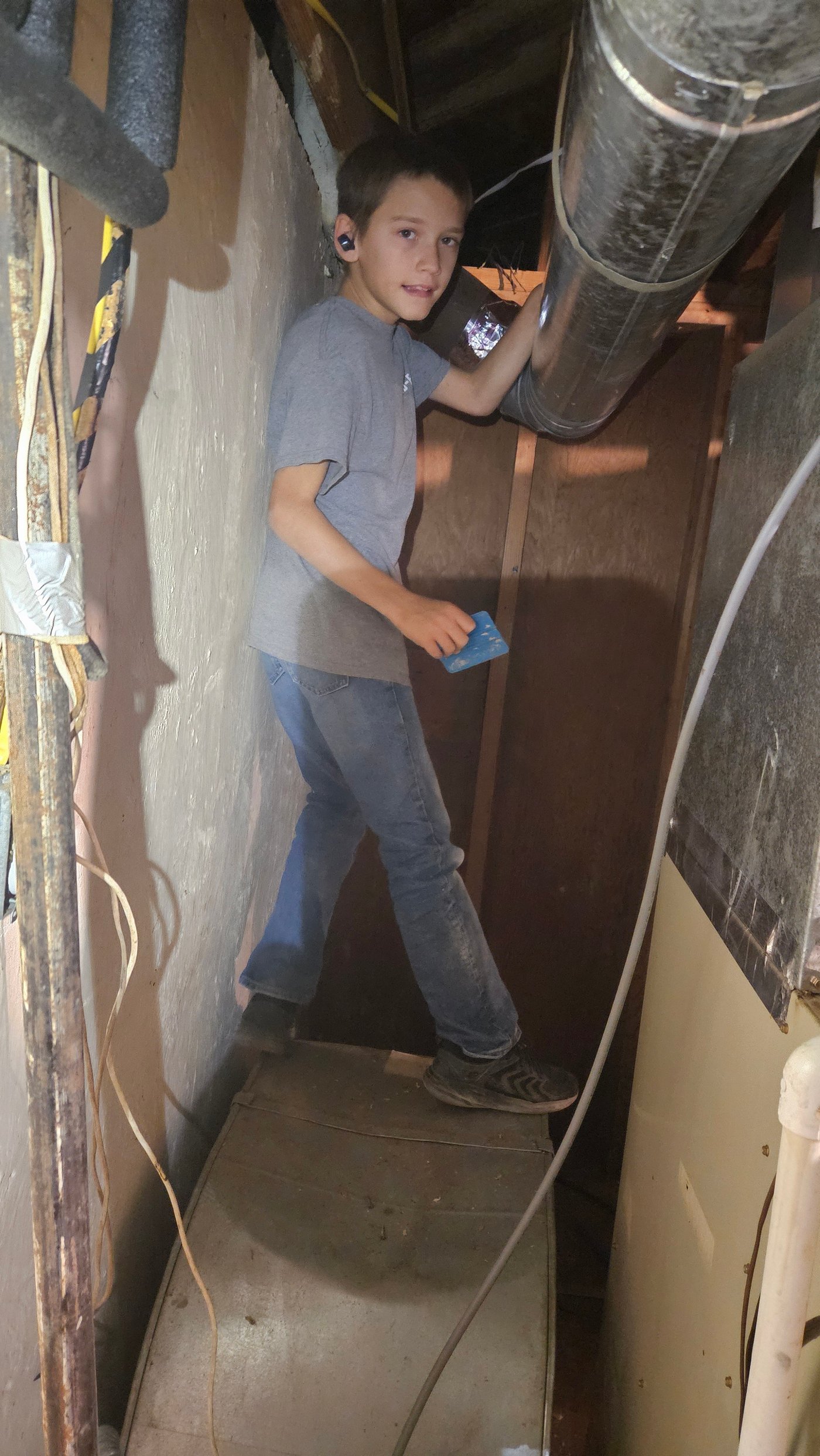 Technician working around ductwork and air handler unit